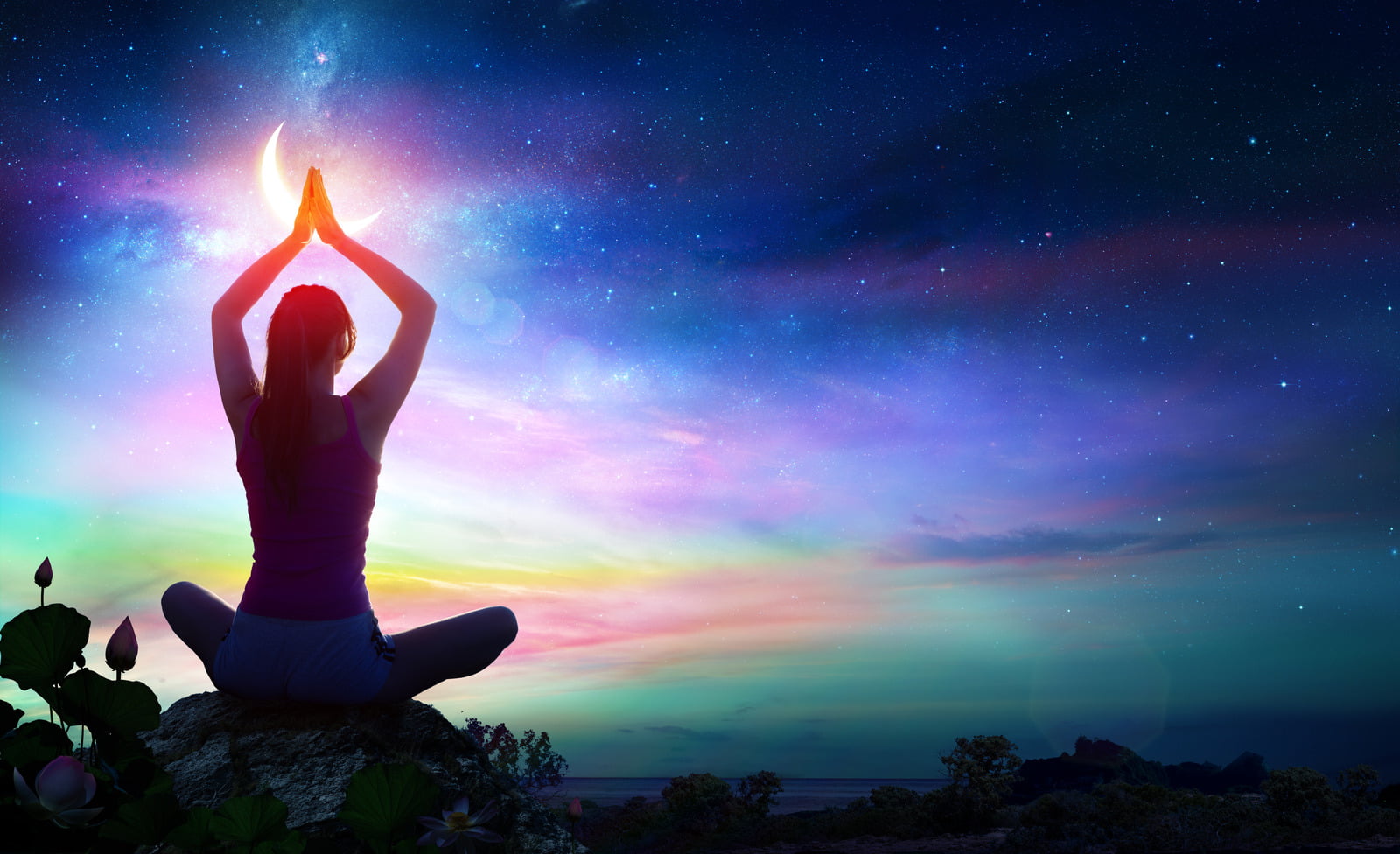 Woman doing yoga in the moonlight